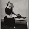 Martha Graham teaching with sheet music and a record player