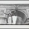 Vito Russo with arms outstretched under the Washington Square Arch