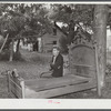 Mr. M.B. Kiechle watching his grandson moving out of the area being taken over by Pine Camp expansion. Mr. Kiechle's own farm is just outside the boundary line of the area. Near Pine Camp, New York.