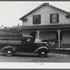 Truck load of household goods at a farm in the Pine Camp expansion area. Most farm families needed several truckloads a day to get their belongings out of the area. Near Pine Camp, New York.