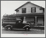 Truck load of household goods at a farm in the Pine Camp expansion area. Most farm families needed several truckloads a day to get their belongings out of the area. Near Pine Camp, New York.
