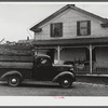 Truck load of household goods at a farm in the Pine Camp expansion area. Most farm families needed several truckloads a day to get their belongings out of the area. Near Pine Camp, New York.