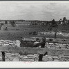 Landscape showing terrain in area being taken over by Pine Camp, New York. In foreground is a barn destroyed by hurricane. Pine Camp, New York.