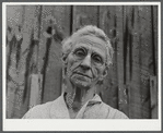 Mrs. Carrie Ward has lived near Leraysville for seventeen years. Now she is planning to move out of the Army camp area to a small farm in Sandy Creek. Her barn is numbered for auctioning. Leraysville, New York.