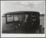 Mr. Herbert Alton, a neighbor, helps Mrs. Earl Barbour move from her home in the Pine Camp expansion area to nearby Evans Mills, New York. Alton himself will soon pack up and move to Syracuse, New York. Near Pine Camp, New York.