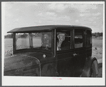 Mr. Herbert Alton, a neighbor, helps Mrs. Earl Barbour move from her home in the Pine Camp expansion area to nearby Evans Mills, New York. Alton himself will soon pack up and move to Syracuse, New York. Near Pine Camp, New York.