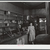 Mr. and Mrs. Merton Hoover in their store and post office in Sterlingville, New York. The Hoovers are moving out of the Pine Camp expansion area to a small house in West Carthage, New York.