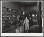 Mr. and Mrs. Merton Hoover in their store and post office in Sterlingville, New York. The Hoovers are moving out of the Pine Camp expansion area to a small house in West Carthage, New York.