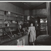 Mr. and Mrs. Merton Hoover in their store and post office in Sterlingville, New York. The Hoovers are moving out of the Pine Camp expansion area to a small house in West Carthage, New York.