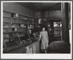 Mr. and Mrs. Merton Hoover in their store and post office in Sterlingville, New York. The Hoovers are moving out of the Pine Camp expansion area to a small house in West Carthage, New York.