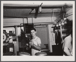 Taking samples of milk for testing at the United Farmers' Cooperative Creamery at East Berkshire, Vermont.