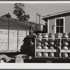 Farmer unloading milk cans at the United Farmers' Co-op Creamery. East Berkshire, Vermont.