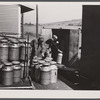 Loading milk cans into a truck at the United Farmers' Co-op Creamery at East Berkshire, Vermont.