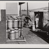 Loading milk cans into a truck at the United Farmers' Co-op Creamery at East Berkshire, Vermont.