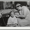 Getting a hair cut at home on a farm near Cambridge Junction, Vermont.