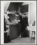 Mrs. W. Gaynor canning tomatoes on their farm near Fairfield, Vermont.