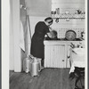 [Mrs. Gaynor at her sink, cleaning a bucket.]
