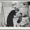 Mrs. Gaynor scrubbing the children's faces before dinner on their farm near Fairfield, Vermont.