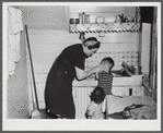 Mrs. Gaynor scrubbing the children's faces before dinner on their farm near Fairfield, Vermont.