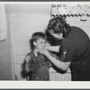 Mrs. Gaynor scrubbing the children's faces before dinner on their farm near Fairfield, Vermont.