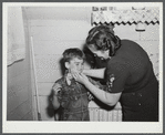 Mrs. Gaynor scrubbing the children's faces before dinner on their farm near Fairfield, Vermont.
