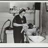 Mrs. Gaynor washing dishes on their farm near Fairfield, Vermont.