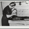 Mrs. W. Gaynor getting potatoes ready to cook for dinner on the Gaynor farm near Fairfield, Vermont.