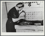 Mrs. W. Gaynor getting potatoes ready to cook for dinner on the Gaynor farm near Fairfield, Vermont.