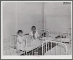 Frederiksted, Saint Croix, Virgin Islands. Child on the left, in the children's ward of the Frederiksted hospital, is suffering from severe malnutrition.