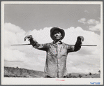 Guanica, Puerto Rico (vicinity). An ox cart driver with a staff used for directing the oxen in a sugar field.