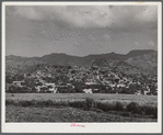 Yauco, Puerto Rico. The town, with slums sprawled on the hillside.