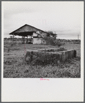 Santurce, Puerto Rico (vicinity). Watering trough and barn on property which FSA (Farm Security Administration) is buying for a land and utility housing project.