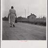 Midwife going on a call, carrying her kit, near Siloam, Greene County, Georgia.