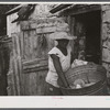 Saint Croix Island, Virgin Islands. Woman washing clothes in the slum village of Saint Johns.