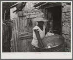 Saint Croix Island, Virgin Islands. Woman washing clothes in the slum village of Saint Johns.