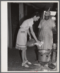 Frederiksted (vicinity), Saint Croix Island, Virgin Islands. Miss Tippin, FSA (Farm Security Administration) home demonstration agent, teaching a FSA borrower how to use a pressure cooker.