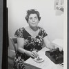 Stella Holt at desk with telephone and cigarette