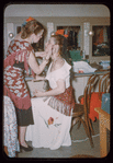 Bidú Sayão applying makeup to Carmen Gracia during a Metropolitan Opera tour of Carmen