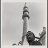 James Baldwin standing before minaret