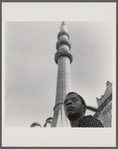 James Baldwin standing before minaret