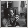 James Baldwin drinking from glass