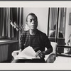 James Baldwin in striped shirt with manuscript