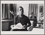 James Baldwin in striped shirt with manuscript