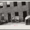 Negroes and their home in the alley dwelling area. Note: building next door is gutted. Washington, D.C.