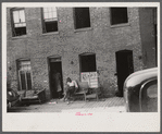 Negroes and their home in the alley dwelling area. Note: building next door is gutted. Washington, D.C.