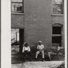 Negroes in front of their homes in the alley dwelling area. Washington, D.C.