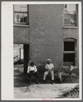 Negroes in front of their homes in the alley dwelling area. Washington, D.C.
