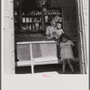 Interior of country store in the hills. Note: everything on the shelves, with the exception of a little coffee and sugar in the glass jars and the bananas hanging from the ceiling, is imported. Puerto Rico.