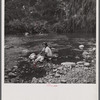 Washing clothes in the river. This is common practice in all rural areas. Puerto Rico.