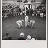 The beginning of the cock fight. When the man in the center raises the cloth, the birds will see each other and begin to fight. Puerto Rico.
